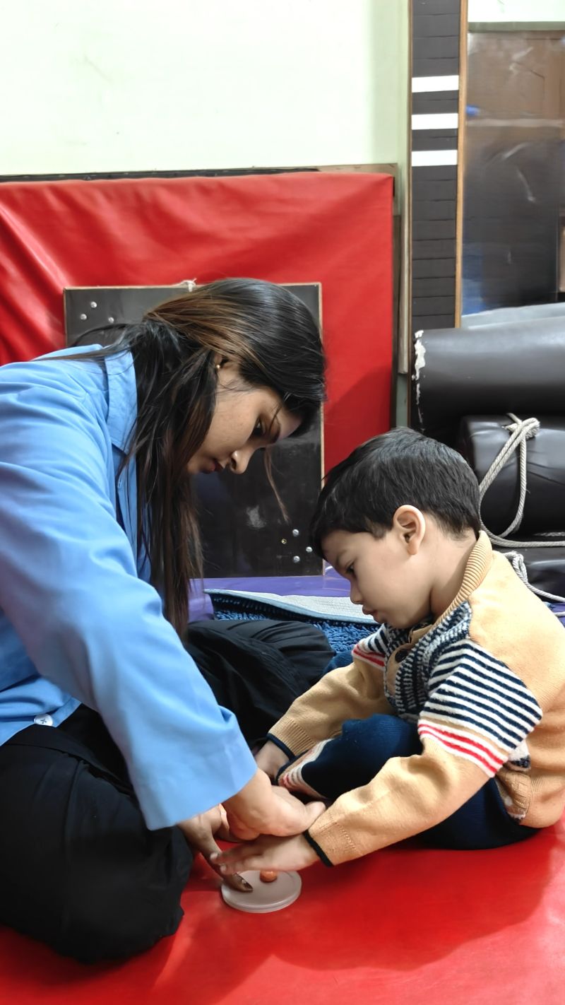 Therapist guiding child through sensory activity session